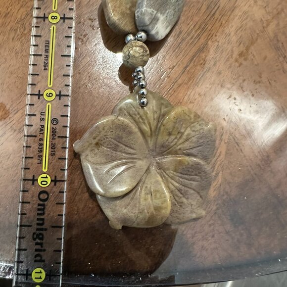 This necklace is a chunky, natural stone necklace with a carved flower pendant - Picture 6 of 10